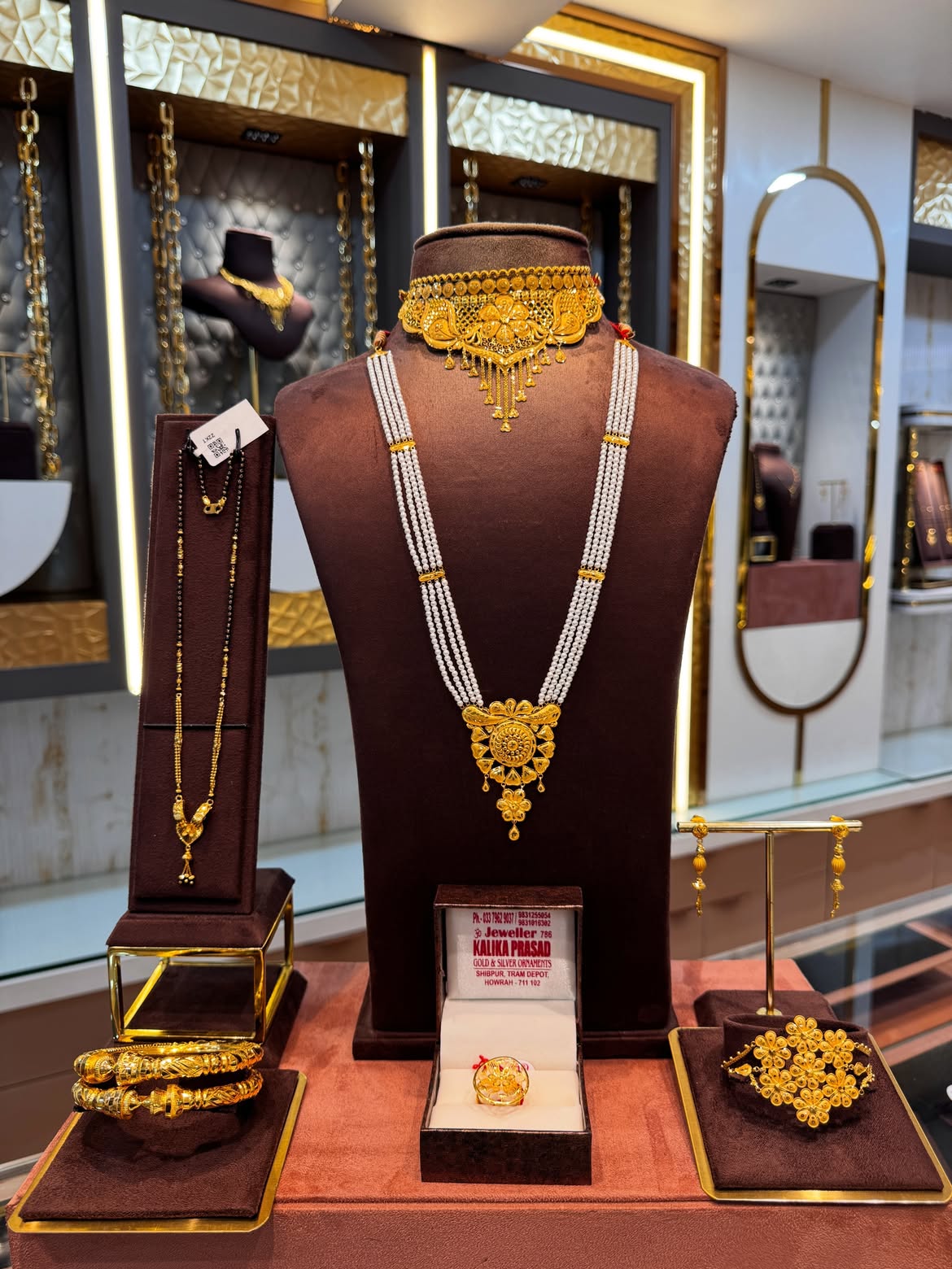 Bridal gold choker, sitahar, bangles and earrings displayed at Jeweller Kalika Prasad showroom